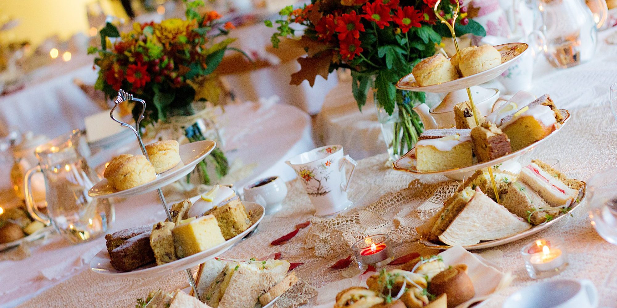 Afternoon tea service with, sandwiches, savory pastries and cakes.